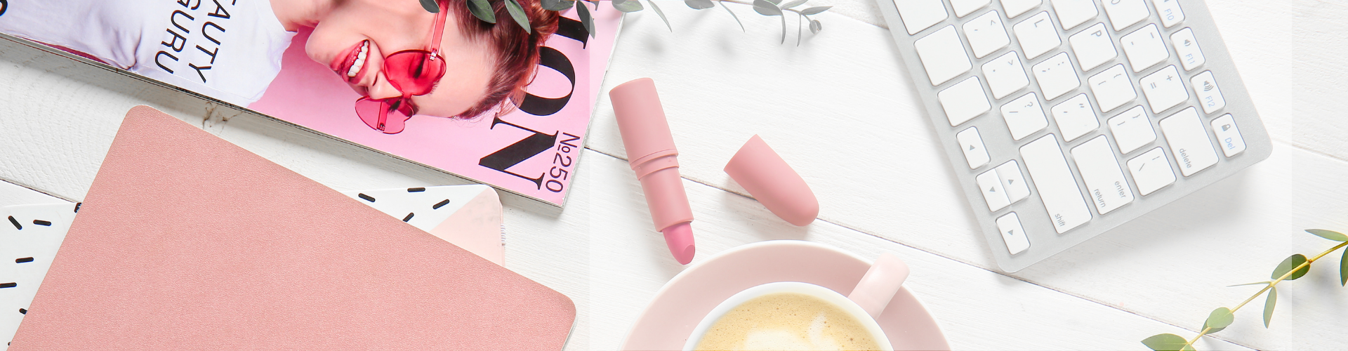 keyboard with lipstick and a magazine