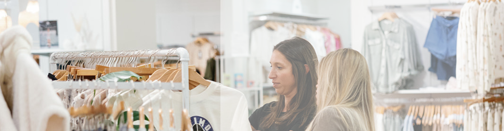 Two women looking through a clothing rack